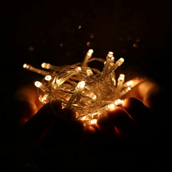 Person meditating peacefully, surrounded by a soft cyan glow.